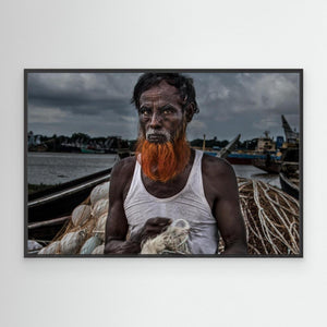 A man from Bangladesh untangling nets. by Joxe Inazio Kuesta Garmendia