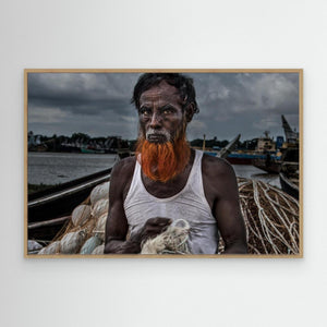 A man from Bangladesh untangling nets. by Joxe Inazio Kuesta Garmendia