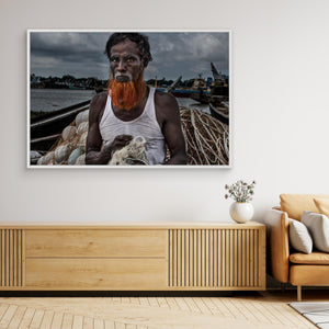 A man from Bangladesh untangling nets. by Joxe Inazio Kuesta Garmendia