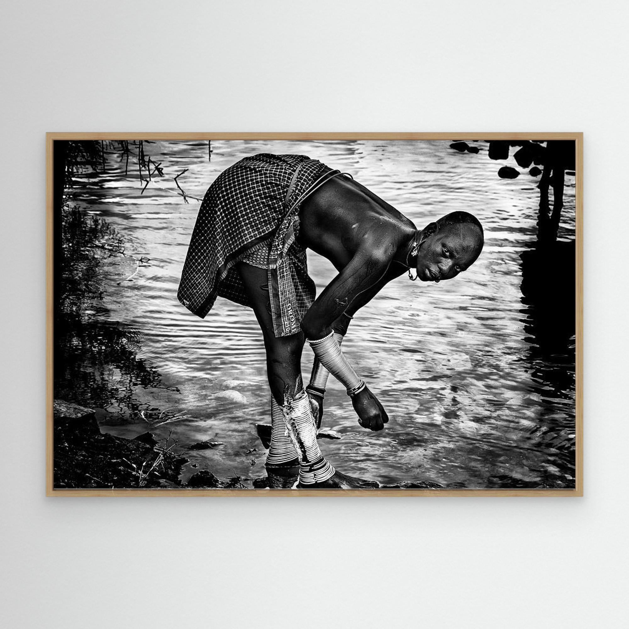 Surma Tribe Woman Washing up her Jewelry - Ethiopia by Joxe Inazio Kuesta Garmendia