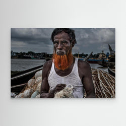 A man from Bangladesh untangling nets. by Joxe Inazio Kuesta Garmendia