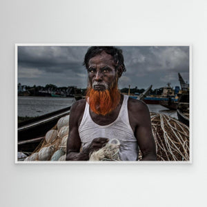 A man from Bangladesh untangling nets. by Joxe Inazio Kuesta Garmendia